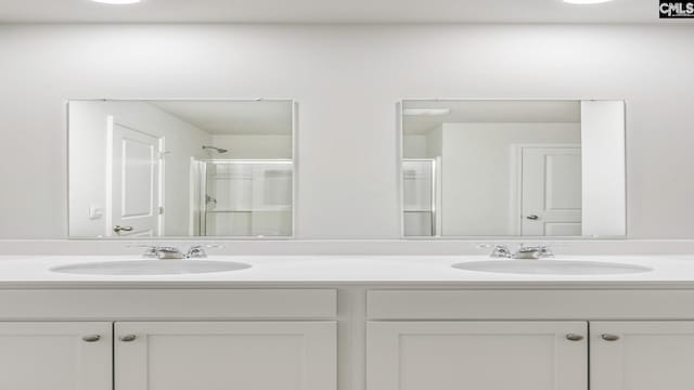 1304 Mosser Dr, Columbia, SC 29203 - bathroom featuring a sink, a shower with shower door, and double vanity