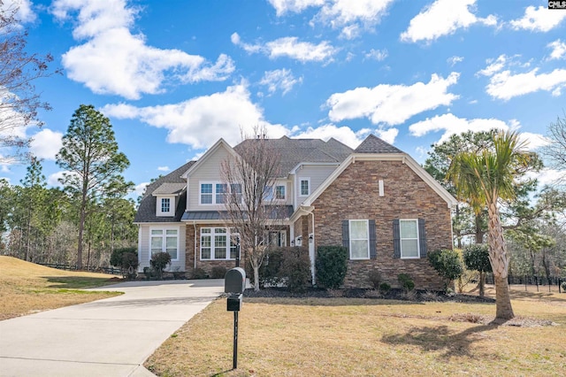 view of front of property with stone siding and a front lawn