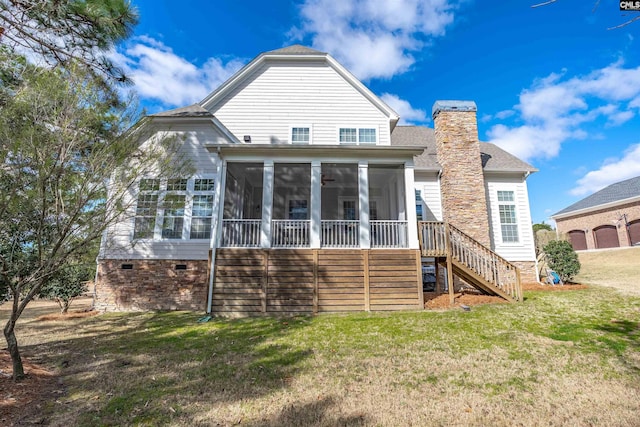 back of house featuring stairway, a yard, a sunroom, and a chimney