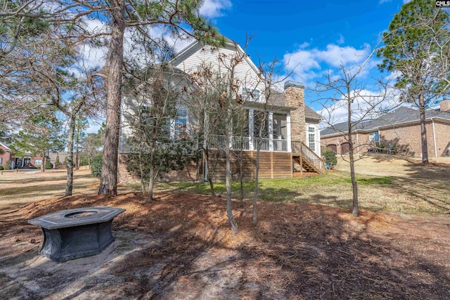 view of yard with stairway and a sunroom