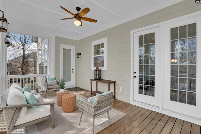 sunroom / solarium featuring a ceiling fan