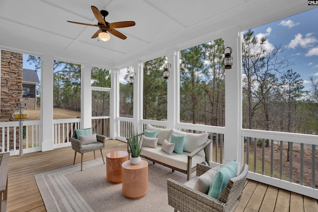 sunroom / solarium featuring a ceiling fan