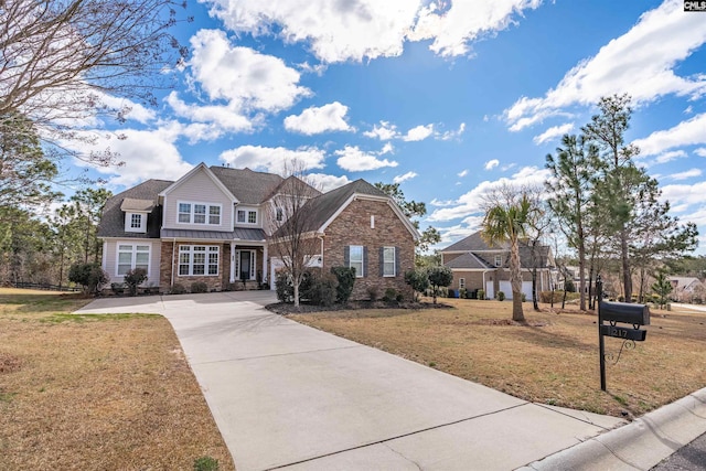 view of front of home featuring concrete driveway and a front yard