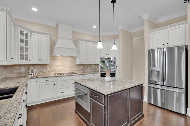 kitchen featuring custom range hood, dark brown cabinets, white cabinets, and stainless steel appliances