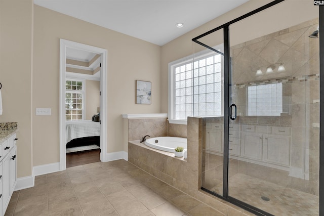 full bath featuring vanity, a shower stall, a bath, and ensuite bath