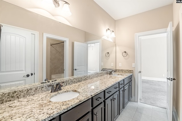 bathroom featuring tile patterned floors, double vanity, a tub, and a sink