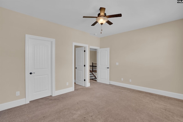 unfurnished bedroom featuring carpet flooring, ceiling fan, and baseboards