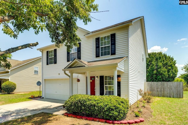 traditional home with fence, a garage, and driveway