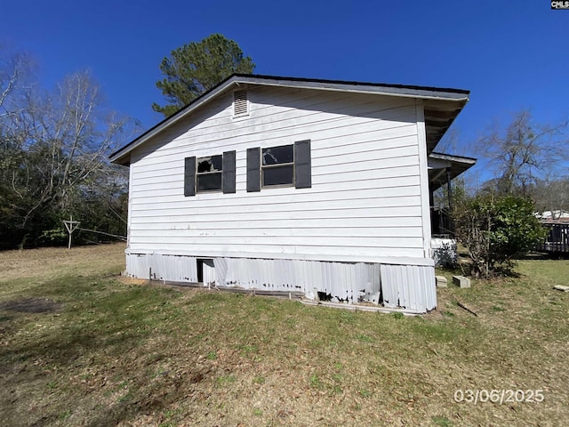 view of property exterior with a lawn