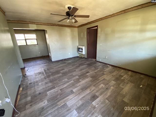 unfurnished room with baseboards, ceiling fan, ornamental molding, wood finished floors, and heating unit