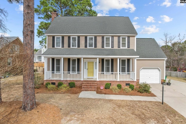 view of front facade with a porch, a chimney, a garage, crawl space, and driveway