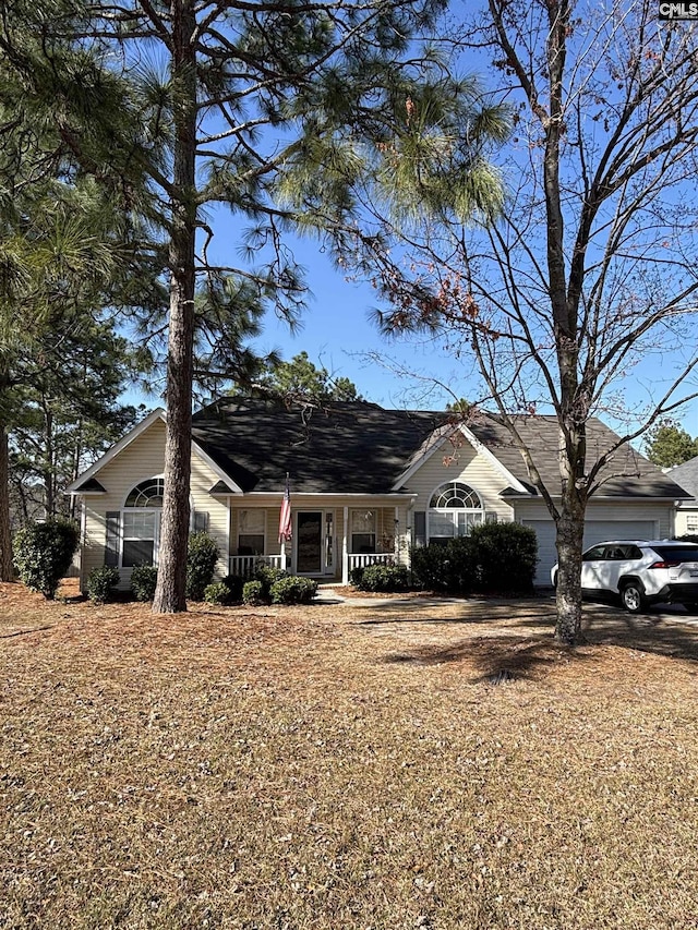 single story home featuring covered porch and an attached garage