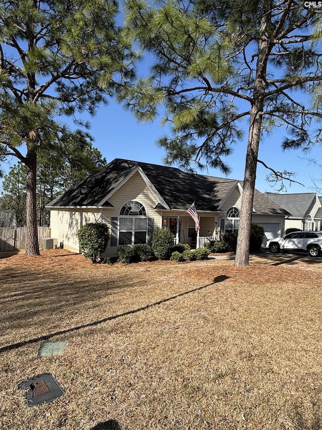 ranch-style home with a garage, a porch, and fence