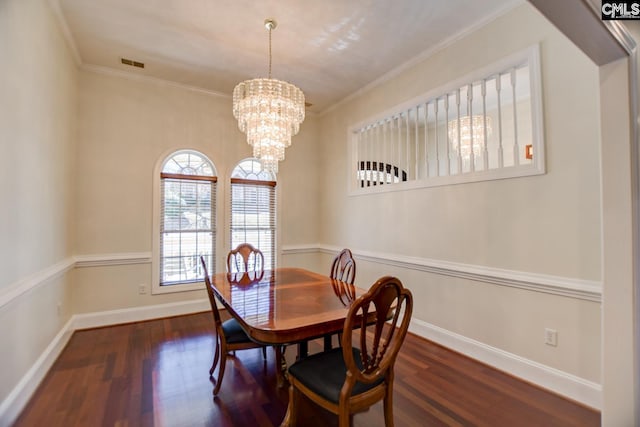 dining space with visible vents, a healthy amount of sunlight, crown molding, and wood finished floors