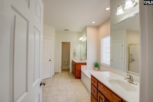 bathroom with tile patterned floors, visible vents, a stall shower, and a sink