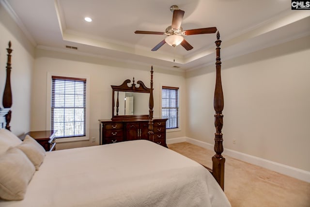 bedroom featuring visible vents, crown molding, baseboards, light carpet, and a raised ceiling