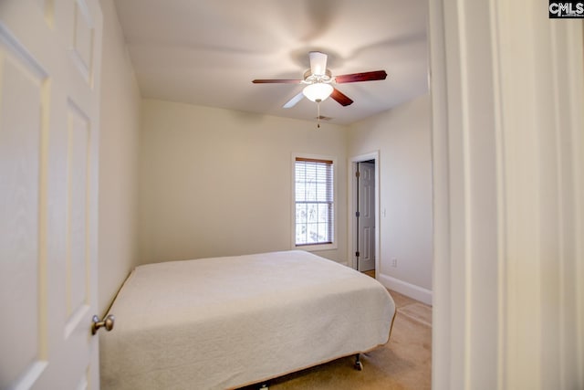 carpeted bedroom with a ceiling fan and baseboards