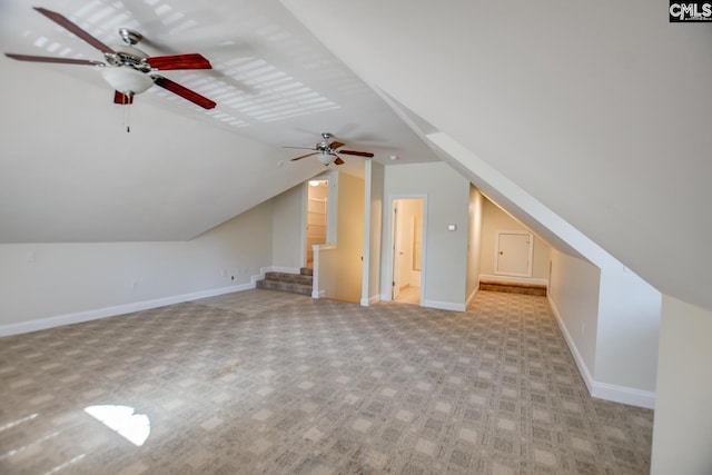 additional living space featuring carpet flooring, baseboards, and vaulted ceiling