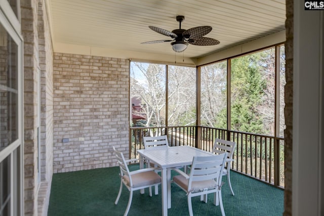 sunroom with plenty of natural light and ceiling fan