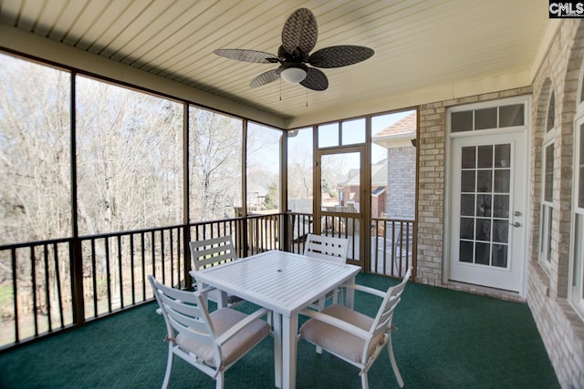 sunroom featuring a ceiling fan