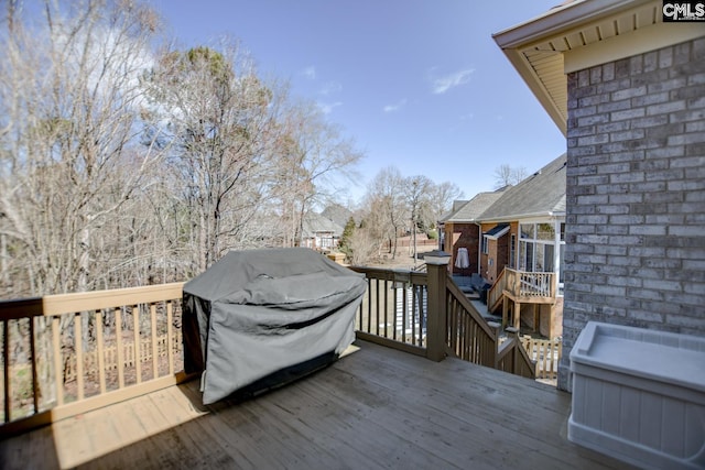 wooden deck featuring area for grilling