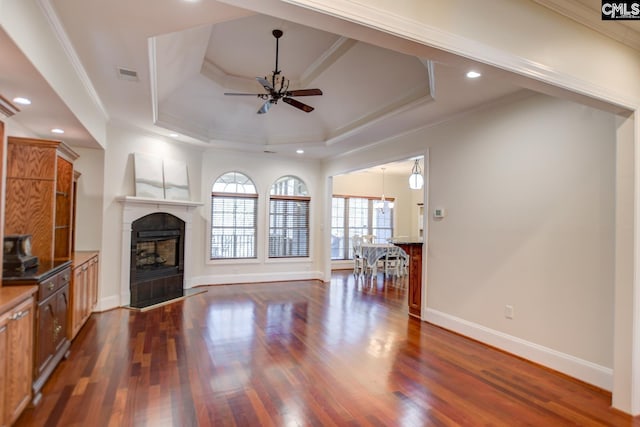 living room featuring visible vents, dark wood-style floors, a fireplace, and crown molding