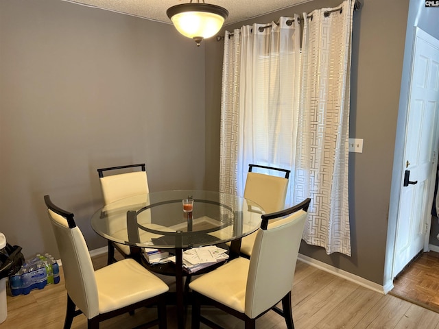 dining room with parquet flooring and baseboards