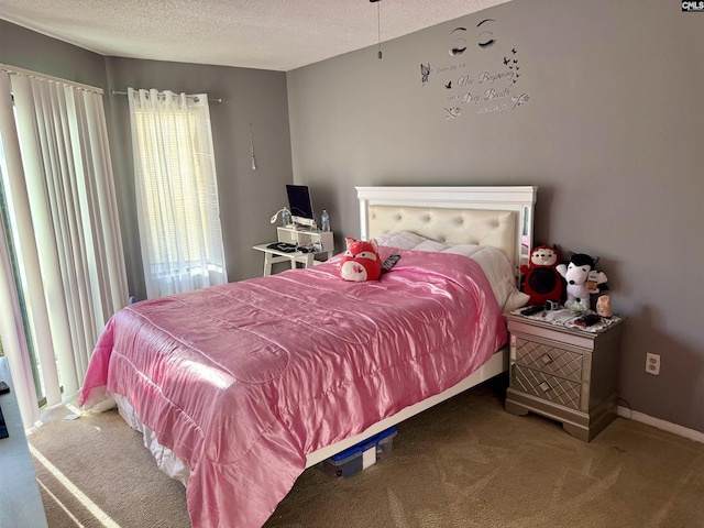 carpeted bedroom with a textured ceiling and baseboards