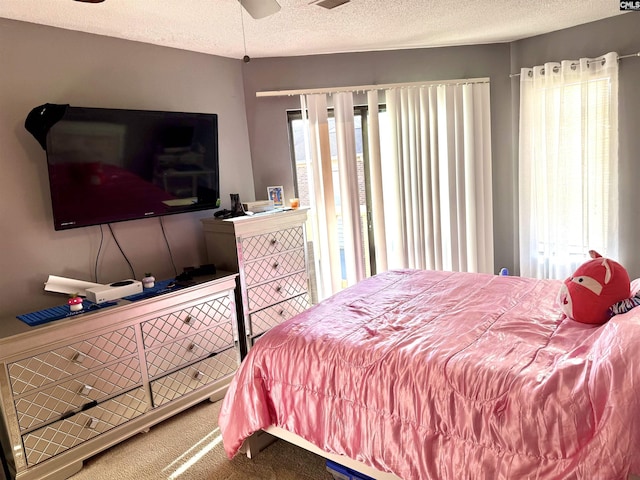 bedroom featuring carpet floors and a textured ceiling