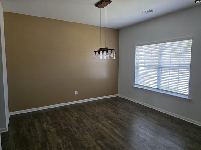 unfurnished dining area with dark wood finished floors, visible vents, and baseboards