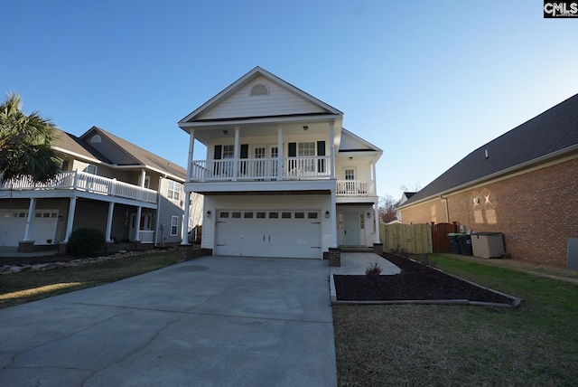 view of front of home with a balcony, driveway, and a garage