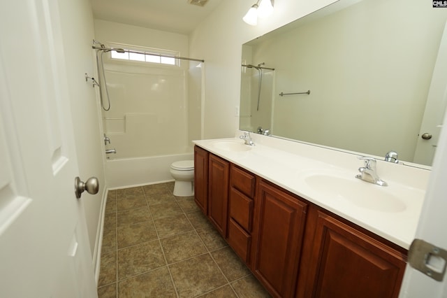 bathroom with tile patterned flooring, double vanity, toilet, and a sink