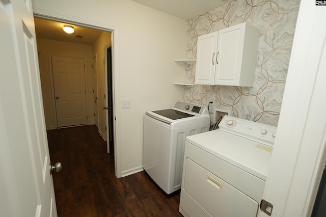 laundry room featuring washer and clothes dryer, cabinet space, wallpapered walls, baseboards, and dark wood-style flooring