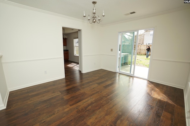 unfurnished room featuring baseboards, a notable chandelier, ornamental molding, and dark wood-style flooring