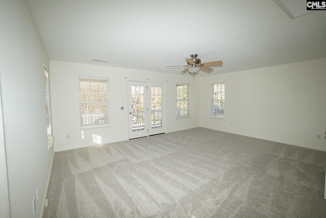 spare room featuring visible vents, baseboards, carpet, and a ceiling fan