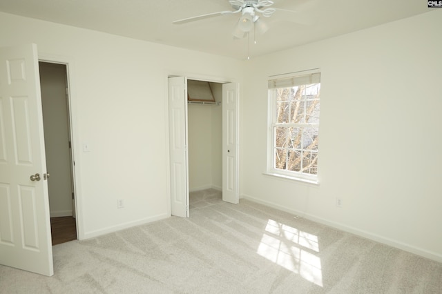 unfurnished bedroom featuring a closet, ceiling fan, baseboards, and carpet