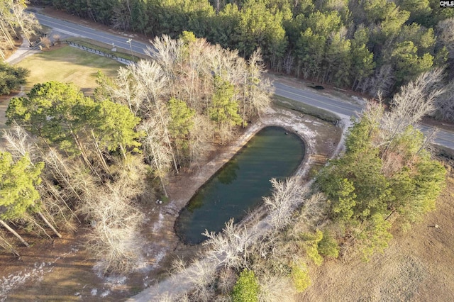 aerial view featuring a forest view and a water view