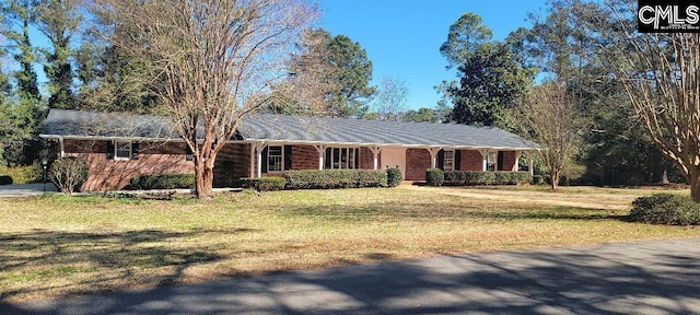 ranch-style house with brick siding and a front yard