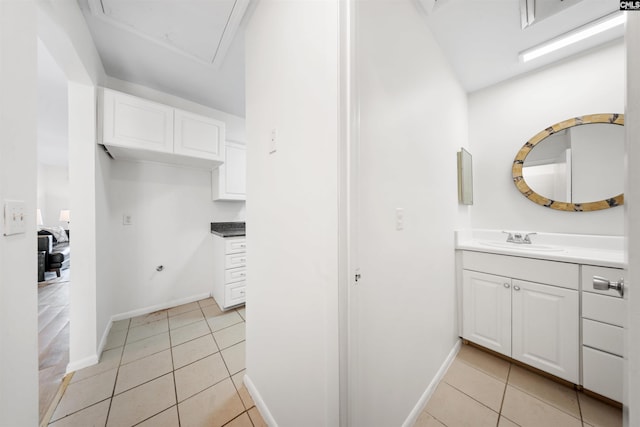 bathroom featuring tile patterned floors, baseboards, and vanity