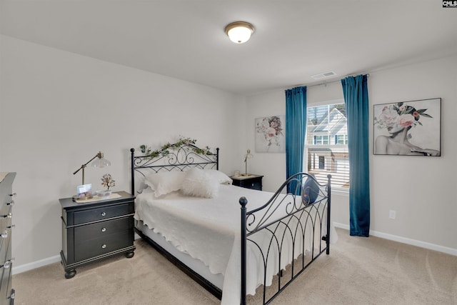 bedroom featuring visible vents, baseboards, and light colored carpet