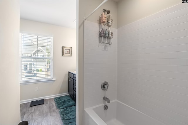 full bath with vanity, shower / bathtub combination, baseboards, and wood finished floors