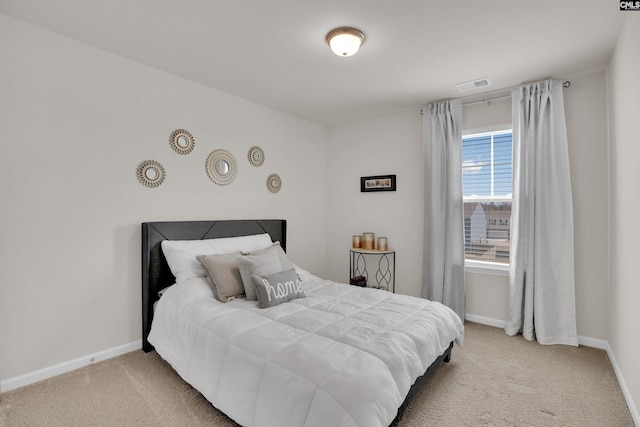 bedroom with visible vents, carpet floors, and baseboards