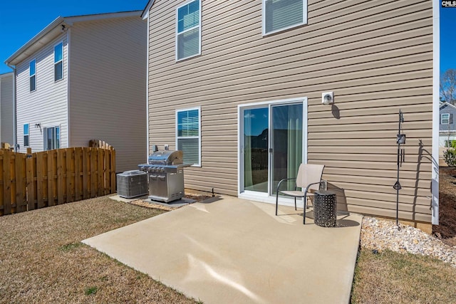 rear view of property featuring central AC unit, a patio, and fence