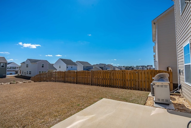 view of yard featuring a patio area, a residential view, and fence