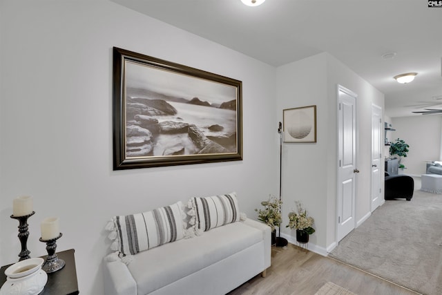 living area featuring baseboards and wood finished floors