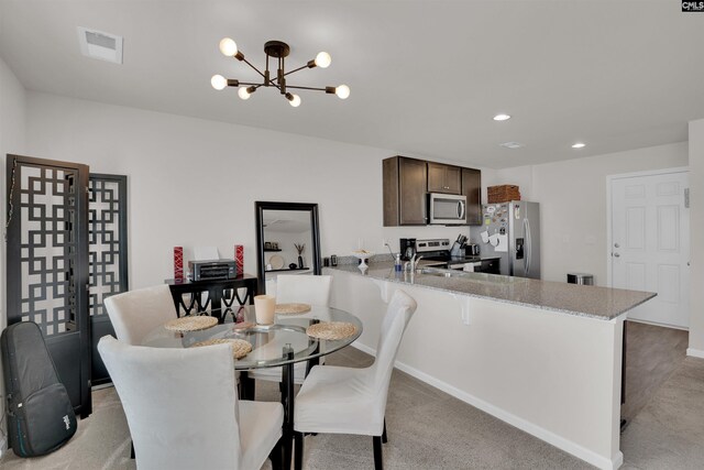 dining space with recessed lighting, visible vents, light colored carpet, and an inviting chandelier