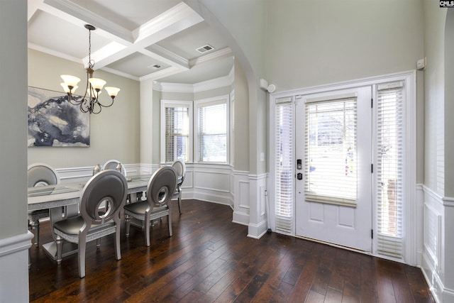 entrance foyer featuring a chandelier, hardwood / wood-style floors, beam ceiling, arched walkways, and coffered ceiling