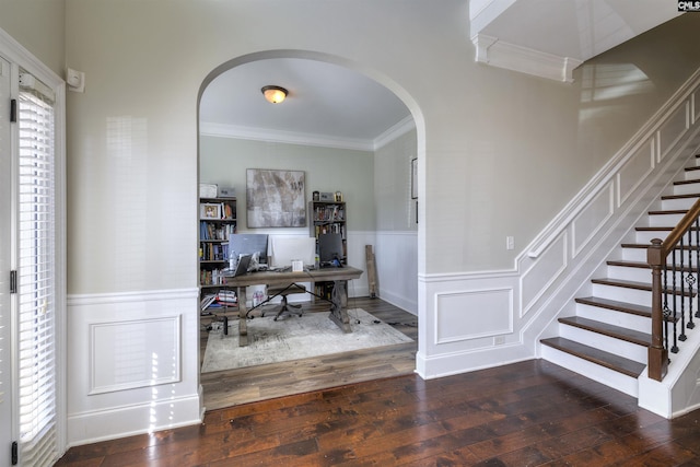 office space featuring arched walkways, wainscoting, hardwood / wood-style floors, and ornamental molding