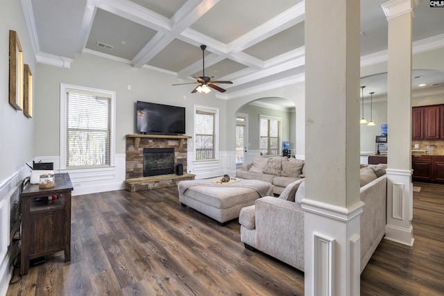 living area with dark wood finished floors, a wainscoted wall, beam ceiling, a fireplace, and coffered ceiling