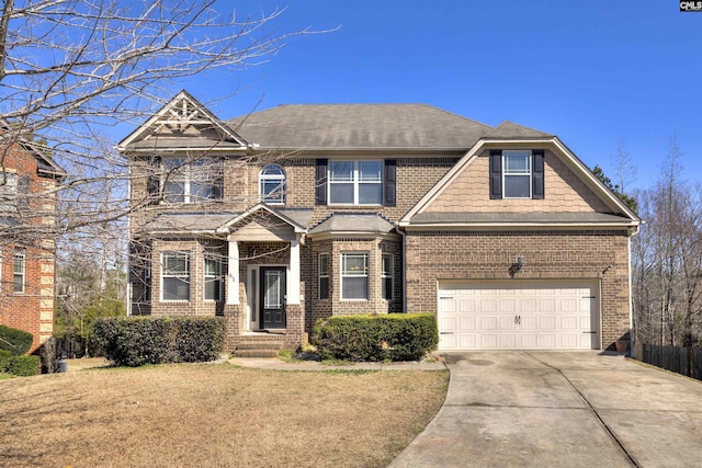 view of front facade with a front yard, brick siding, and driveway